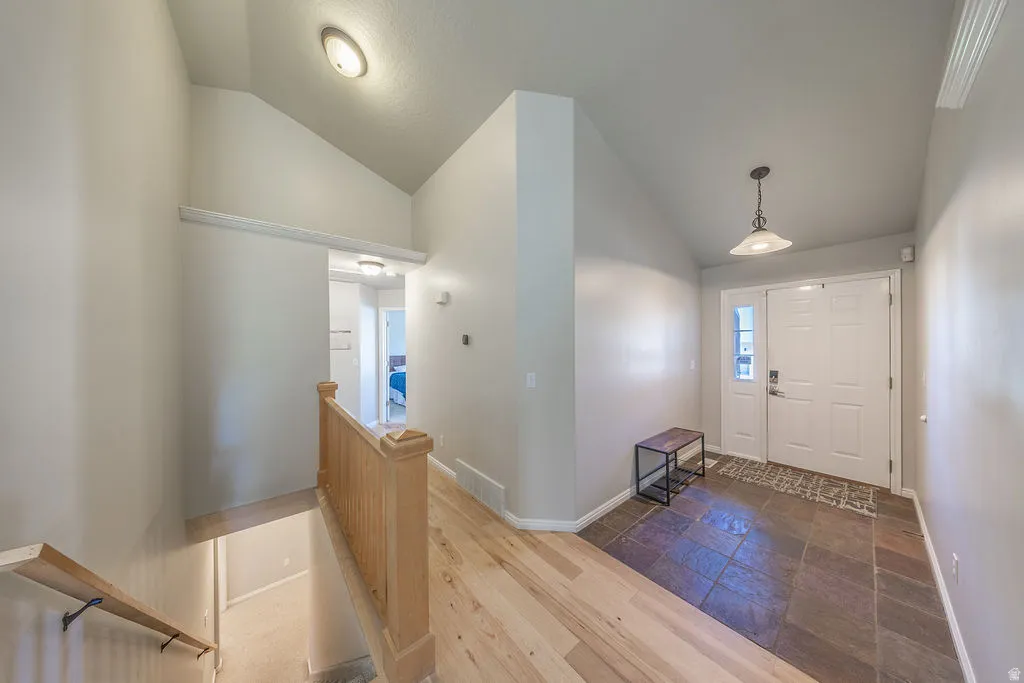 Entryway featuring a double door, transom window, and slate tile flooring