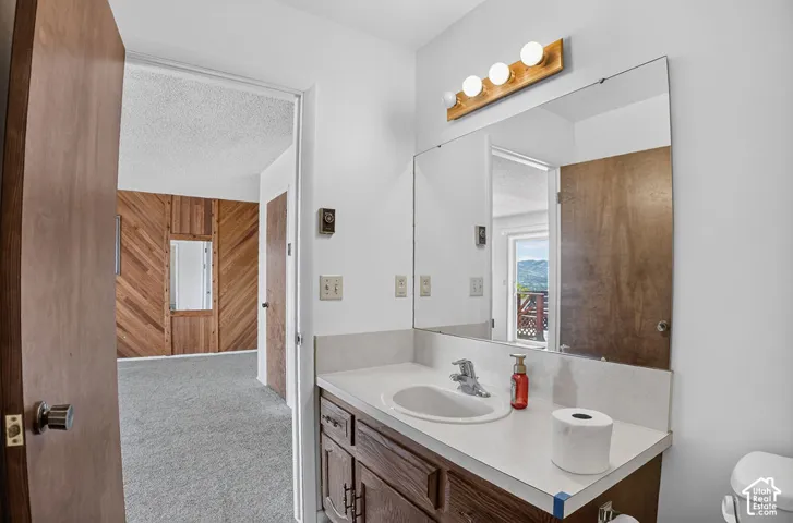 Bathroom vanity with an integrated sink and wood-finish cabinetry