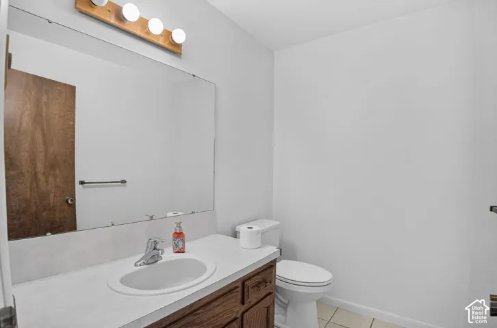 Wood-finish vanity with an integrated sink and chrome faucet