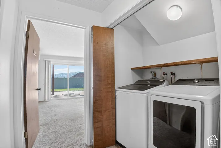 Laundry area with built-in shelving and appliances
