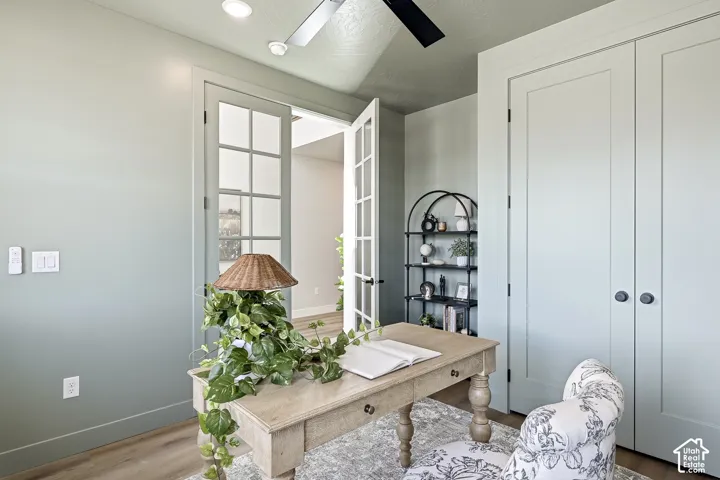 Recessed lighting, wood-finish flooring, French doors, and built-in closet with dark hardware