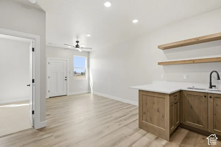 Wood-finish flooring, recessed lighting, and a ceiling fan