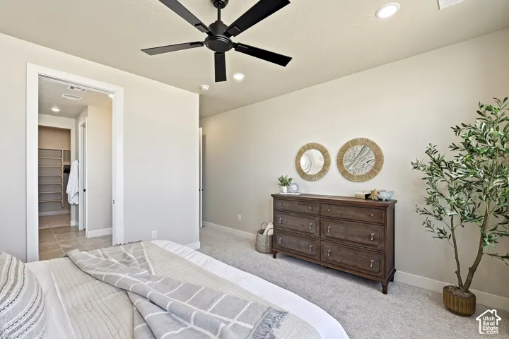 Recessed lighting, ceiling fan, plush carpet flooring, custom closet shelving, and tile flooring