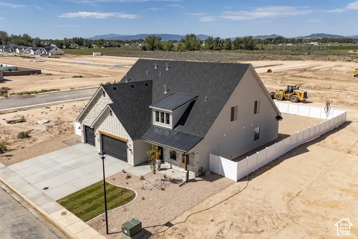 Modern farmhouse architecture with a dark shingle roof and metal accent roofing
