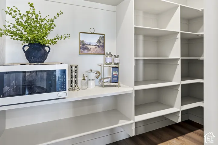 Integrated shelving with a built-in countertop, providing substantial storage and a dedicated appliance area
