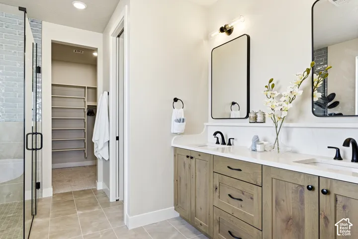 Dual vanity with light wood-finish cabinetry and quartz countertops