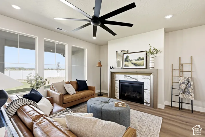 Recessed lighting and a multi-blade ceiling fan complement the natural light