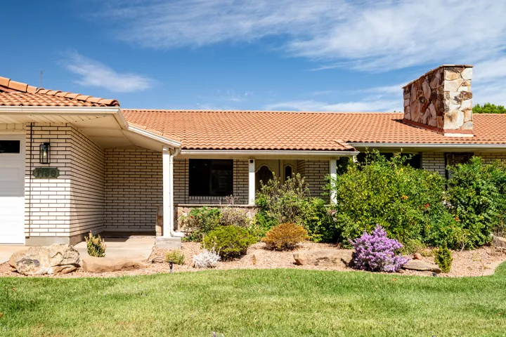 White brick exterior with a terracotta tile roof