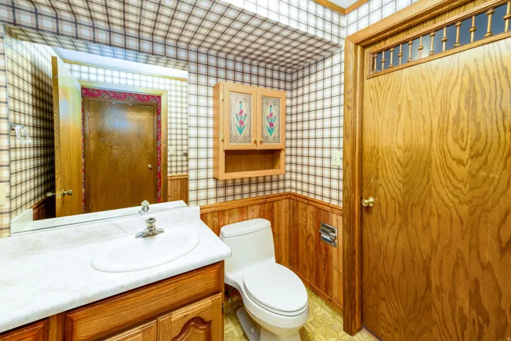 Built-in vanity with a white basin and a light-colored countertop
