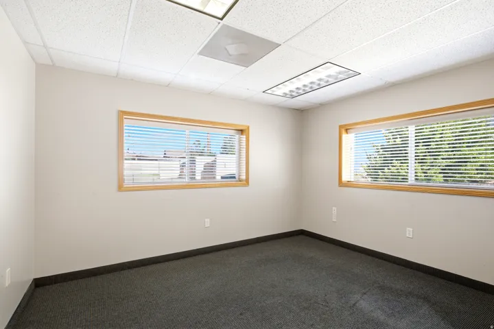 Textured acoustic tile ceiling with recessed lighting