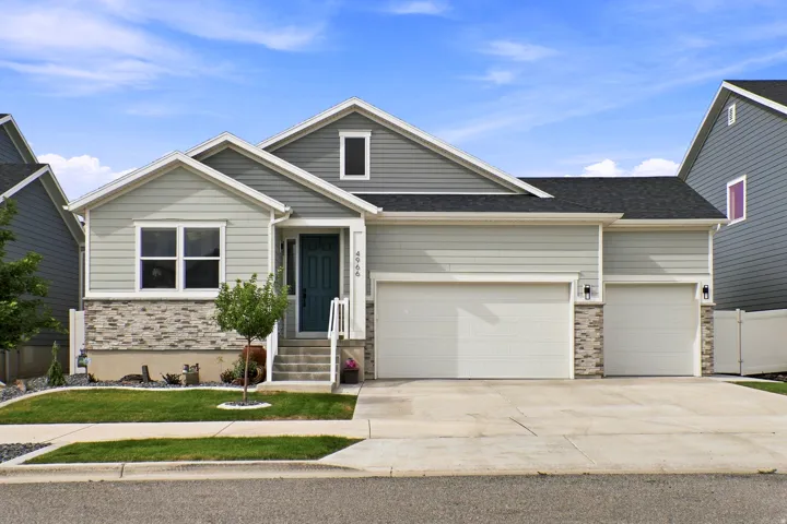 Light green siding with dark gray shingle roof