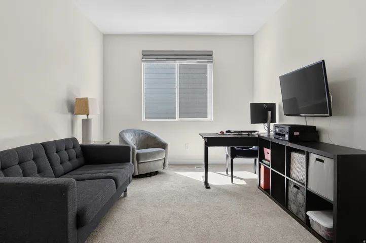 Wall-to-wall carpeting and a window with blinds