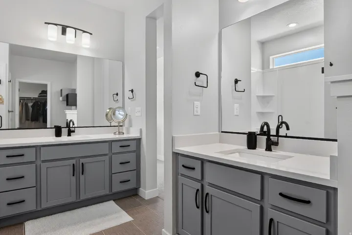 Dual vanities with gray cabinetry