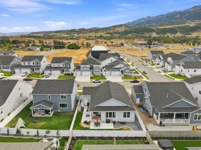 Mountain backdrop, new construction neighborhood, residential streets, detached garages, white privacy fencing