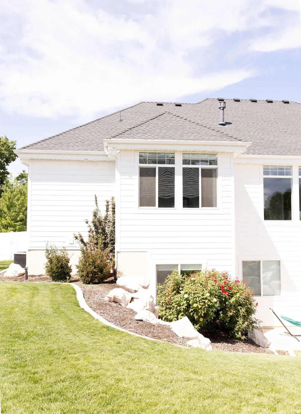 White siding exterior with multiple windows