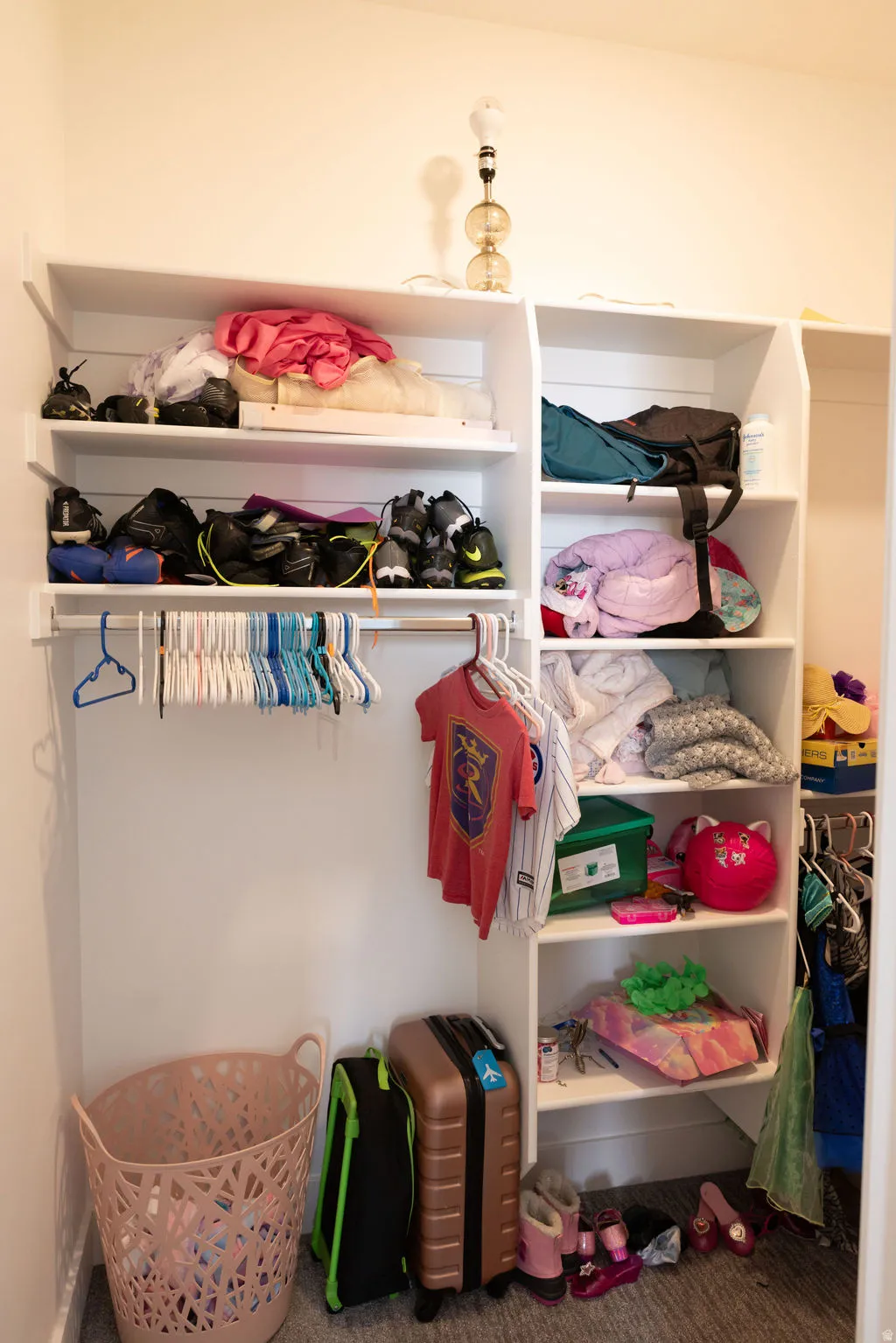 Built-in closet system with multiple shelving units and hanging rods