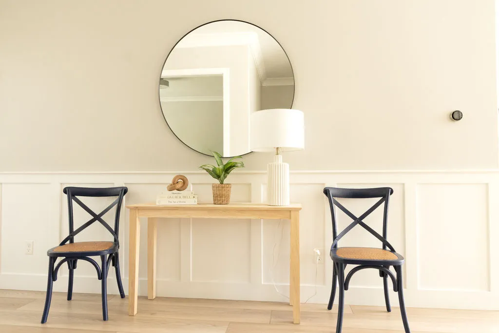 Wall paneling with a crisp white finish and light-toned wall paint