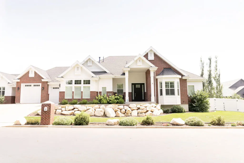 Brick and white siding exterior with a dark roof