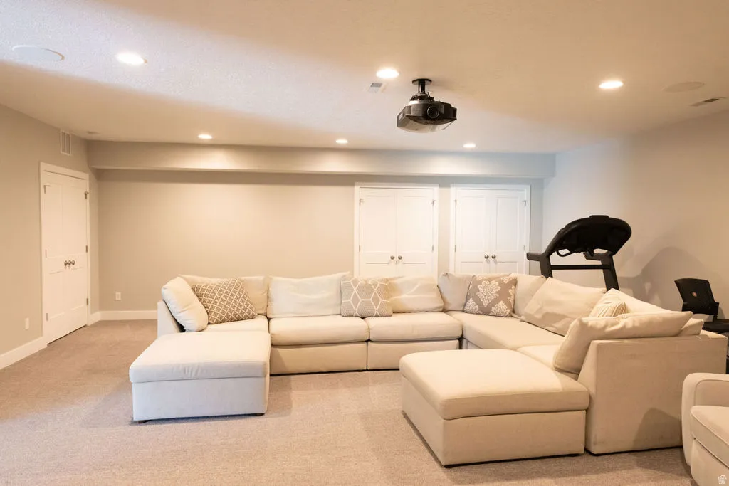 Recessed lighting, ceiling-mounted projector, wall-to-wall carpeting, white interior doors