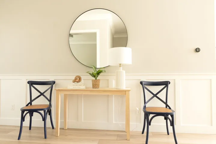 Wall paneling with a crisp white finish and light-toned wall paint
