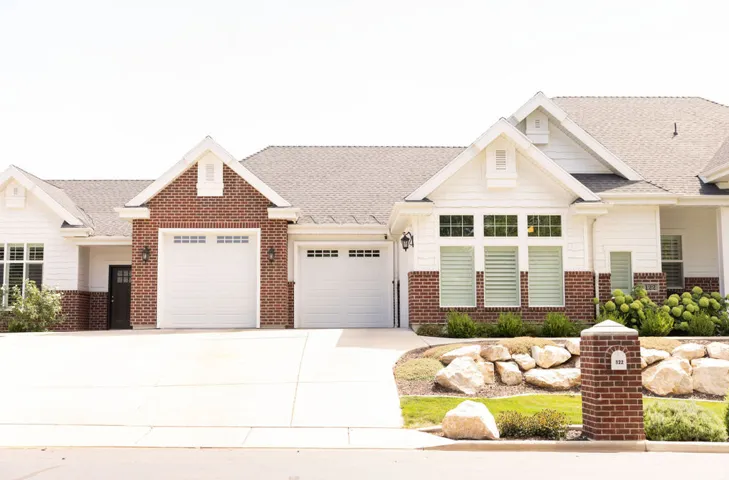 Brick and siding exterior with a shingled roof