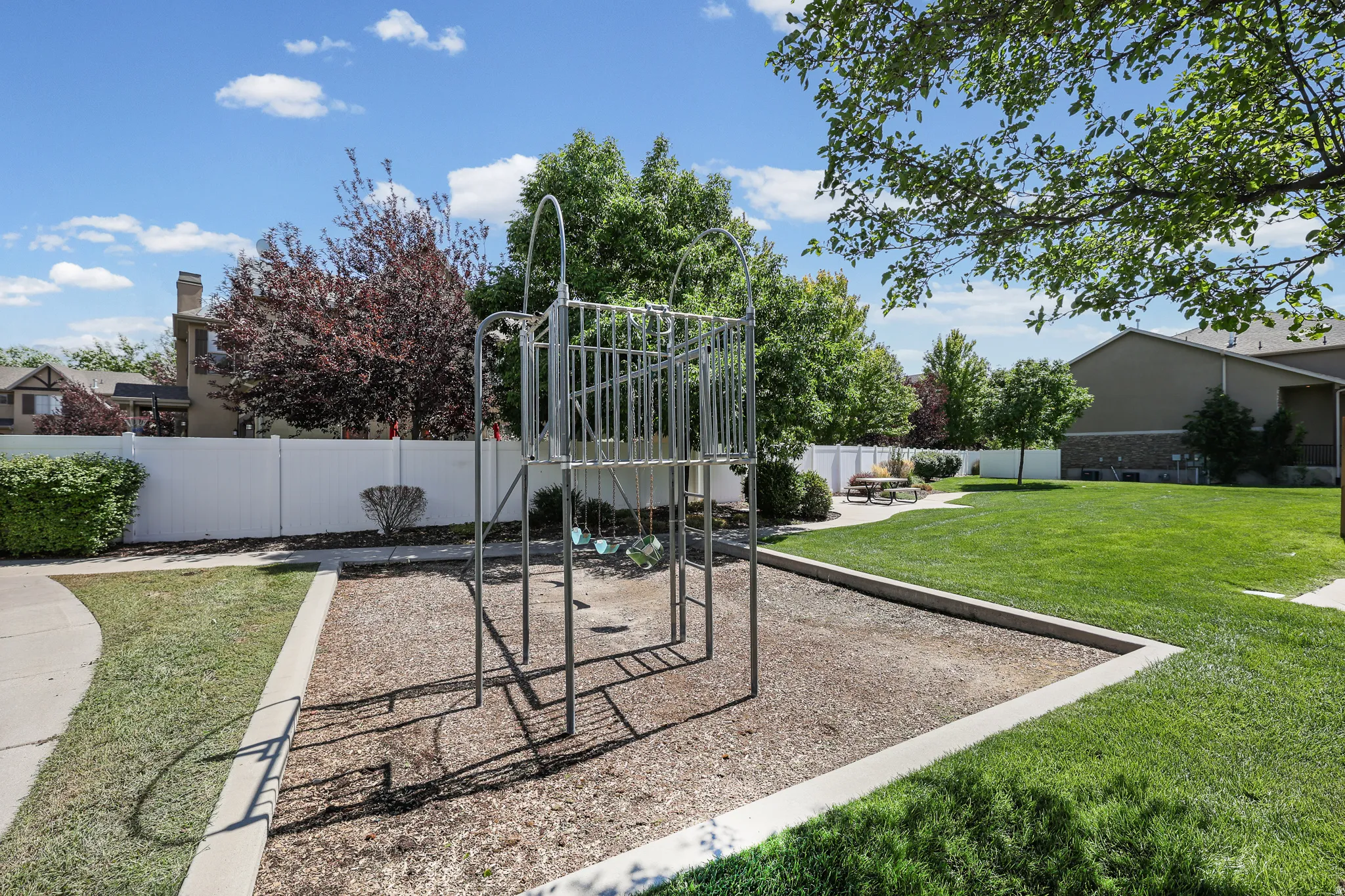 Community Grassy area with Playground and picnic tables