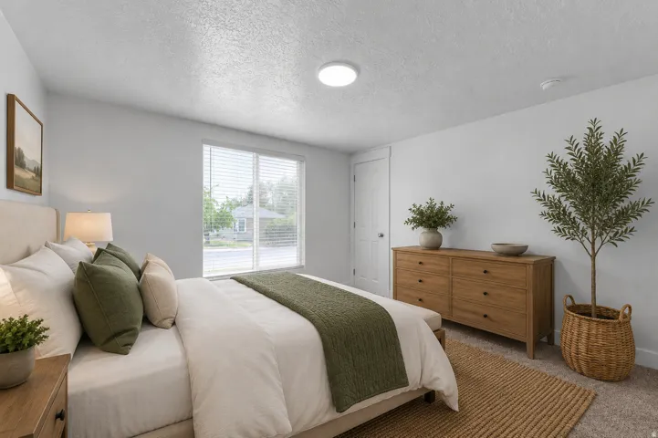 Virtually staged. White walls, recessed lighting, and a window with blinds