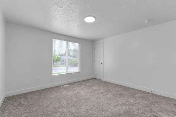 Gray carpeting with white trim and walls