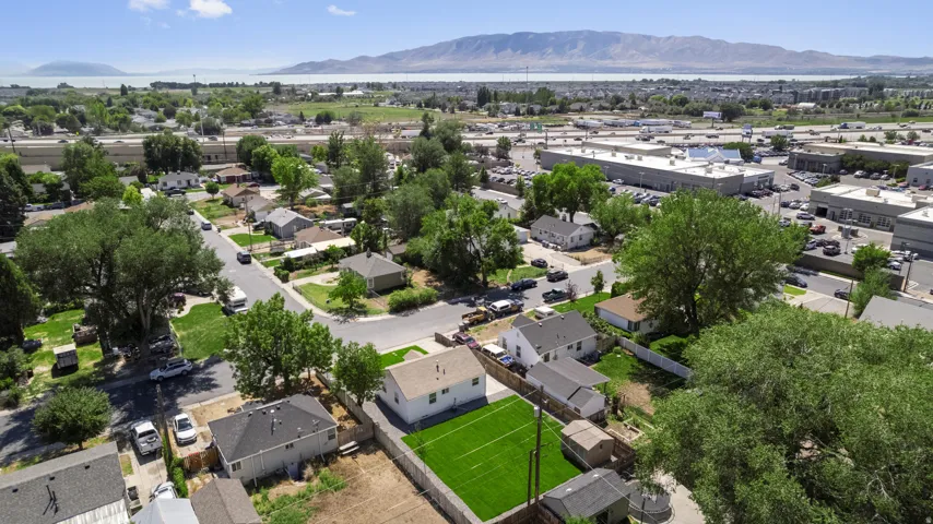 Residential property featuring a large grassy yard and a single-story structure