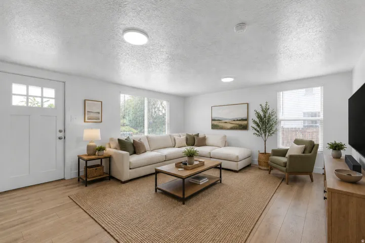 Virtually staged. Wood-finish flooring, white paneled door with windowpanes, multiple windows with blinds, and recessed lighting