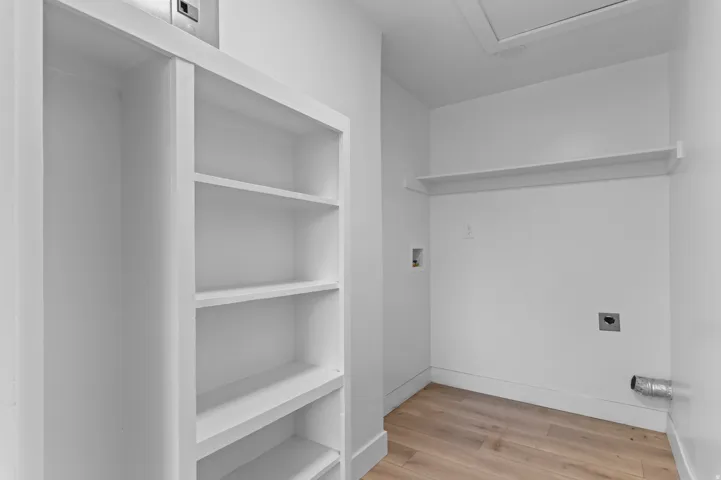 Built-in shelving, wood-finish flooring, and wall-mounted shelving