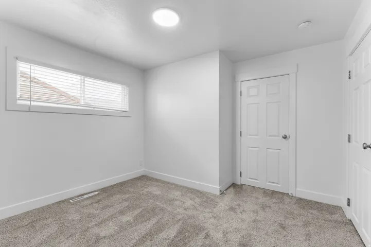 Recessed lighting, horizontal window with blinds, paneled interior doors, and plush carpeting
