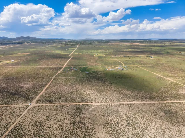 Expansive land featuring natural terrain with distant mountain outlines