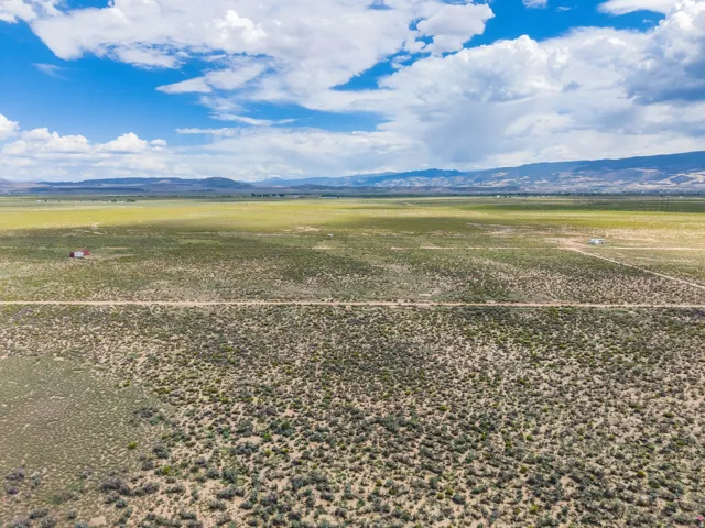 Expansive open terrain with a long, unpaved road