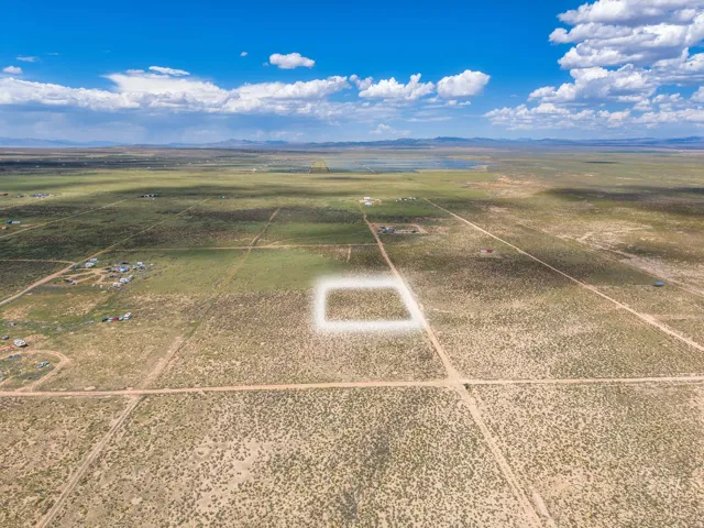 Expansive open land with a desert landscape, defined by existing roadways and distant mountain ranges