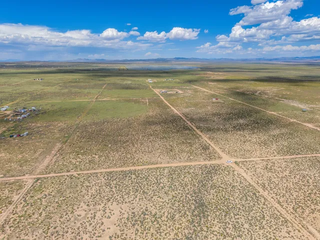 Expansive undeveloped land featuring natural vegetation and distant mountain ranges
