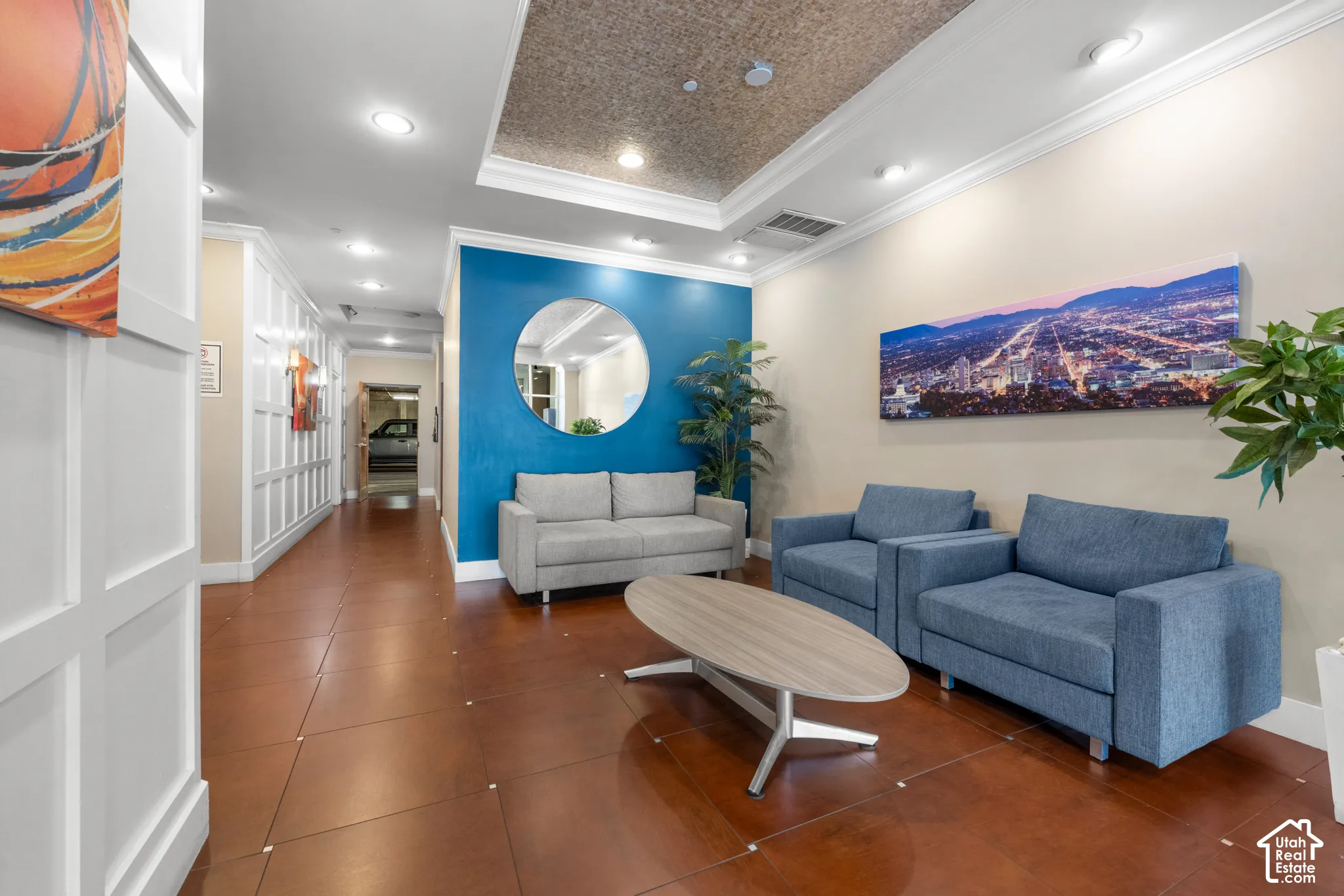 Crown molding and recessed lighting complement the textured ceiling