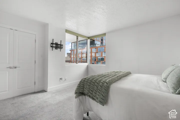 Owners suite with corner windows and an urban backdrop