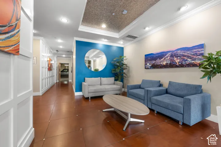 Crown molding and recessed lighting complement the textured ceiling