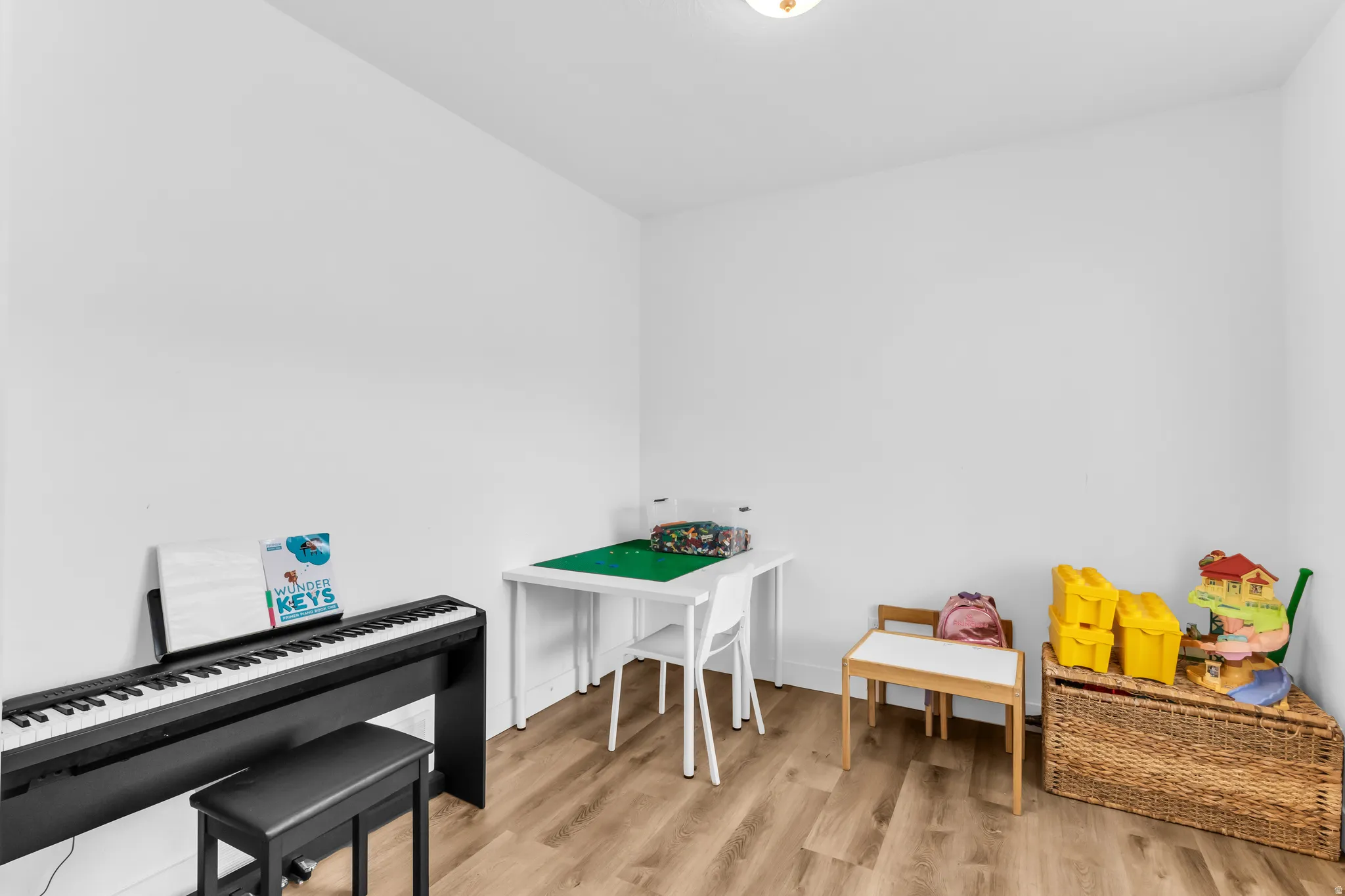 Recessed lighting and light wood-finish flooring complement the neutral wall tones