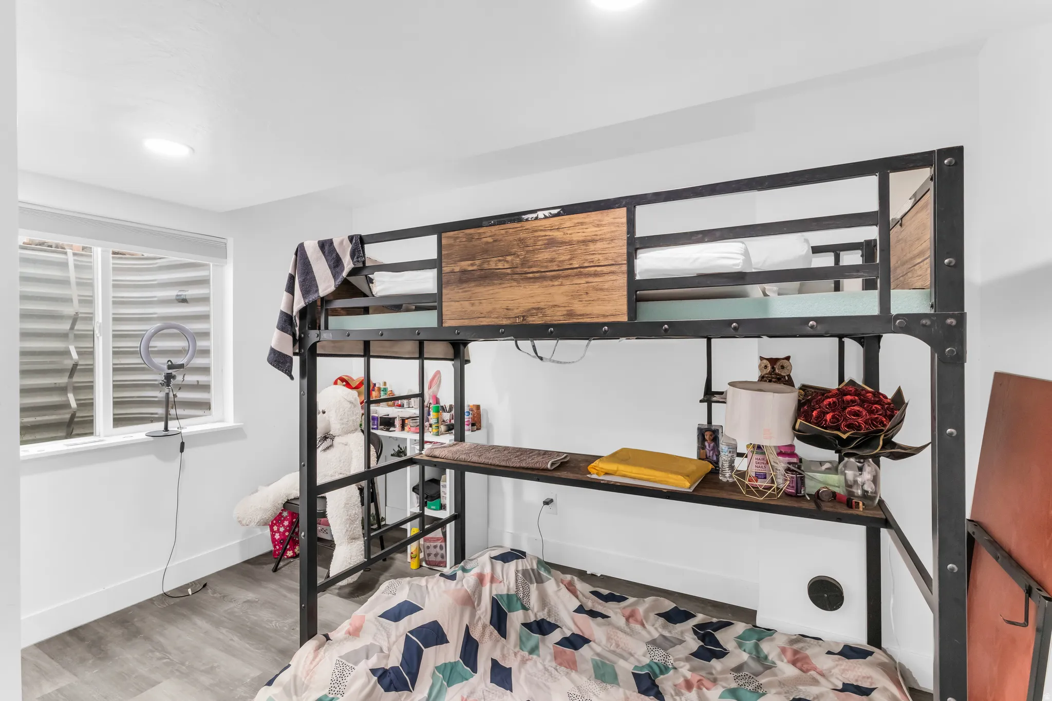 Recessed ceiling lighting, a window with a white frame, light wood-finish flooring, and white painted walls