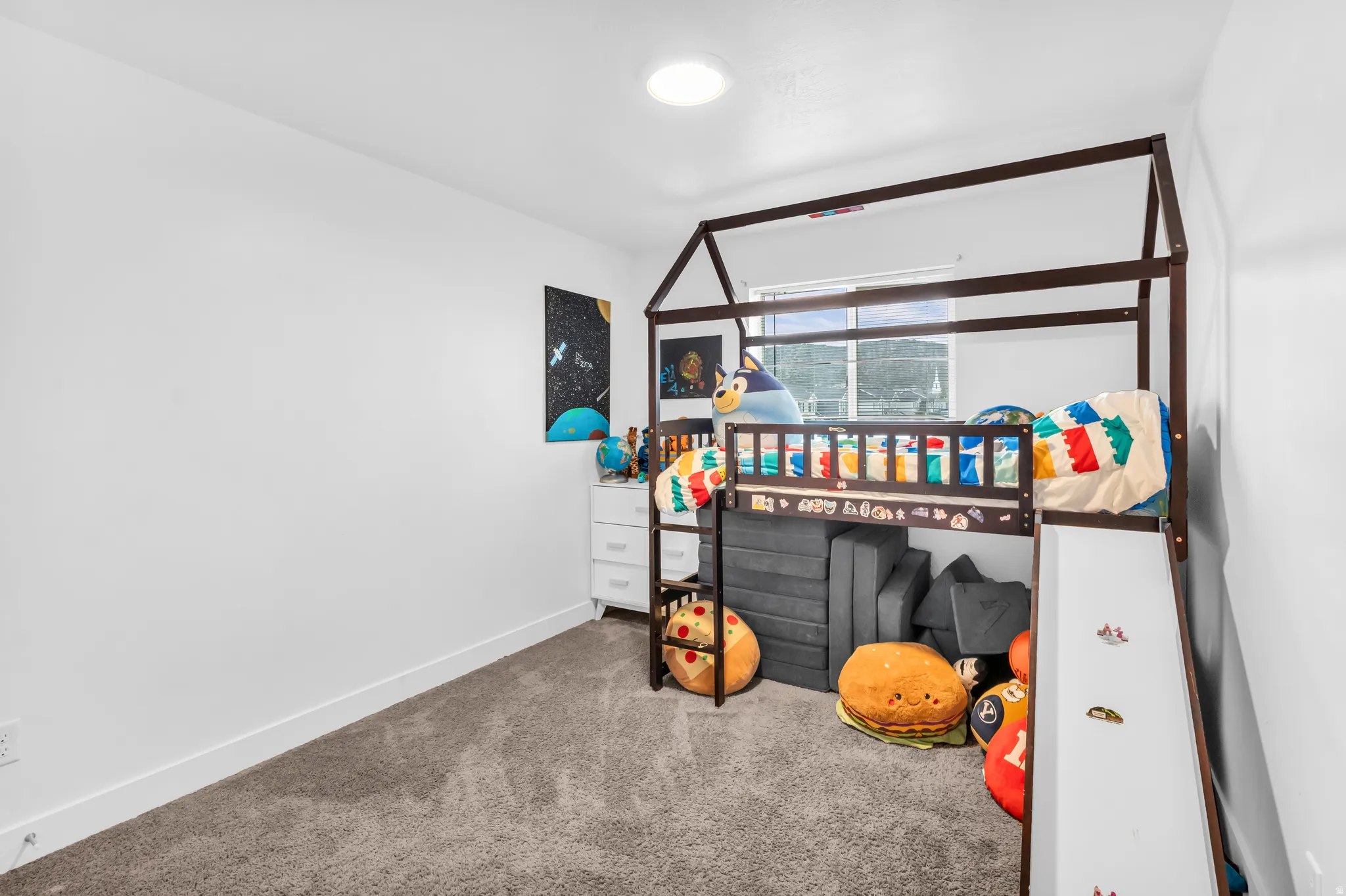 Recessed ceiling light, white walls, and carpet flooring