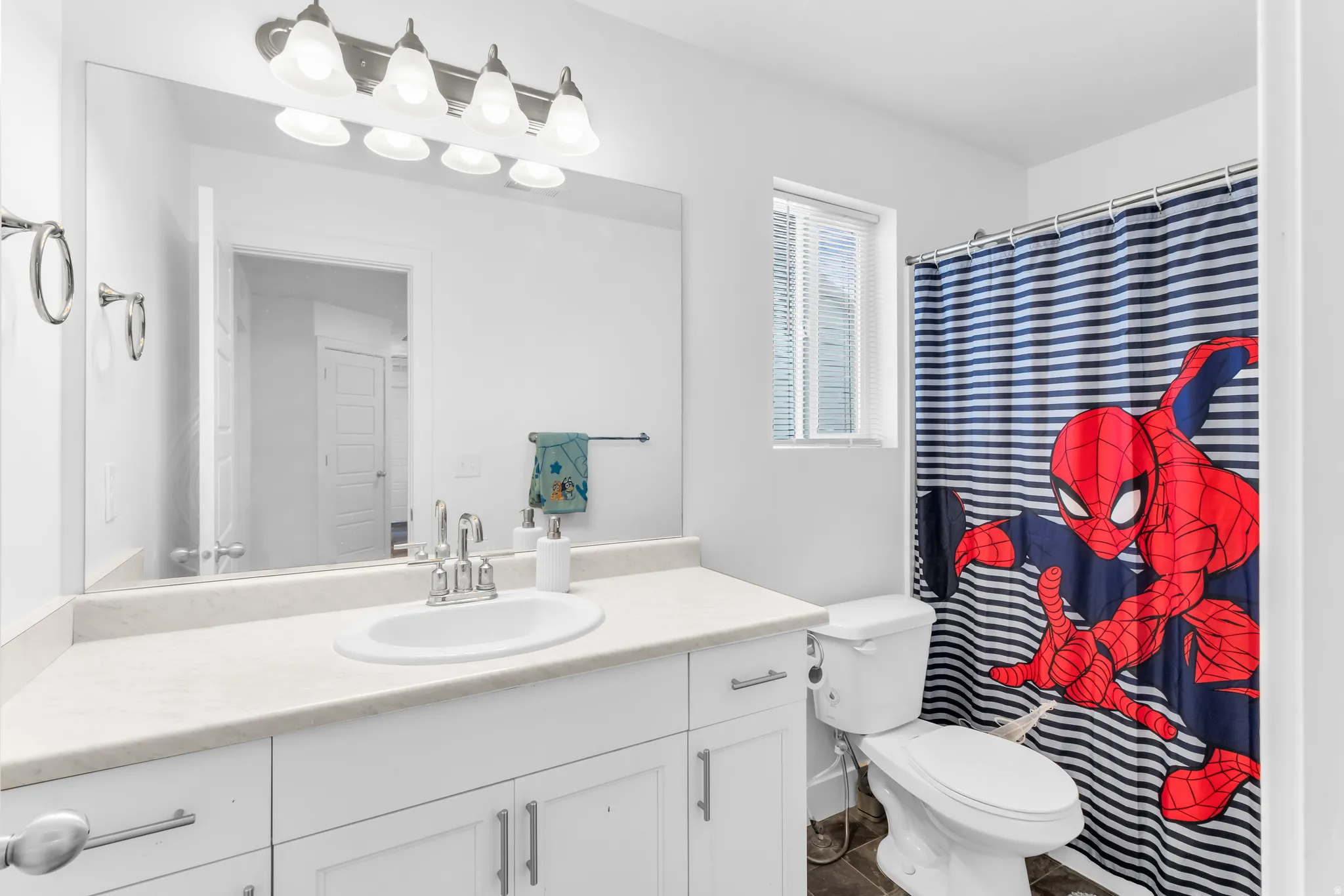 Vanity with an integrated sink, polished chrome faucet, and quartz-finish countertop