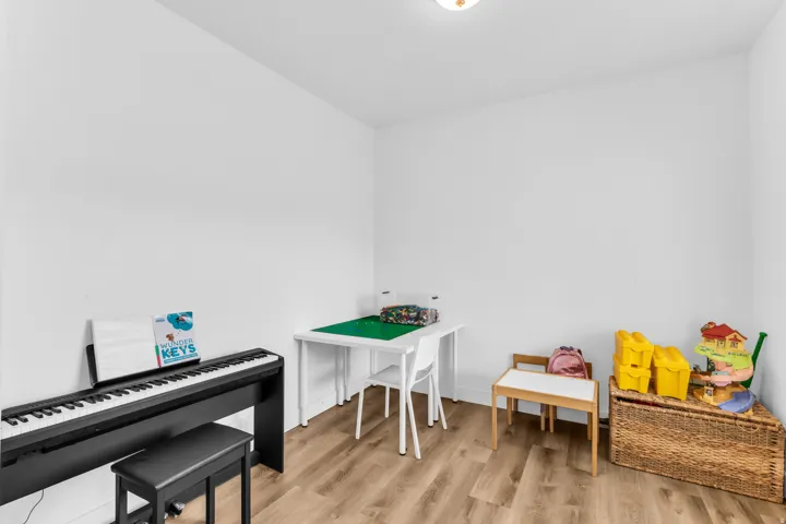 Recessed lighting and light wood-finish flooring complement the neutral wall tones