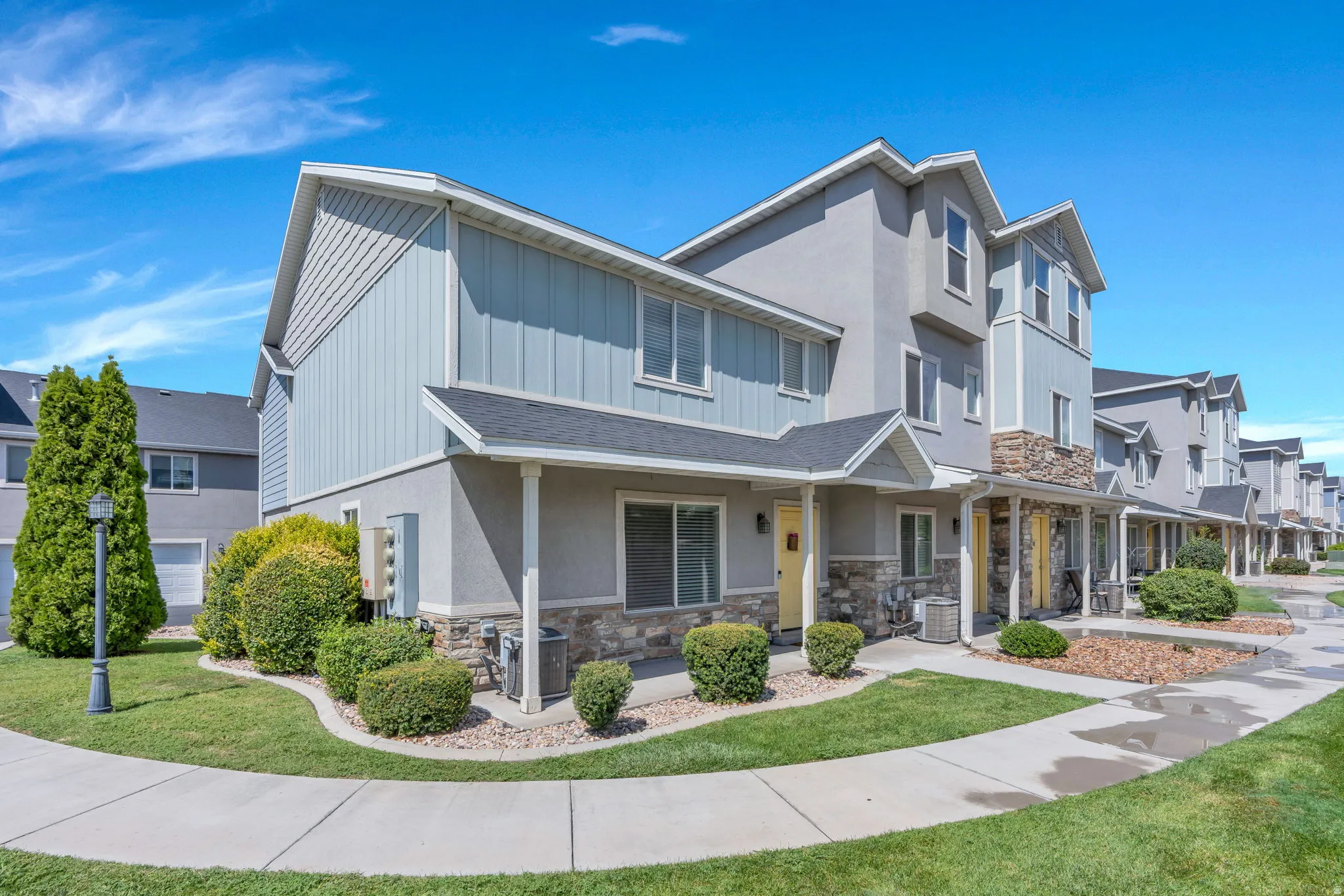 Exterior featuring stone accents, siding, stucco, and a covered porch