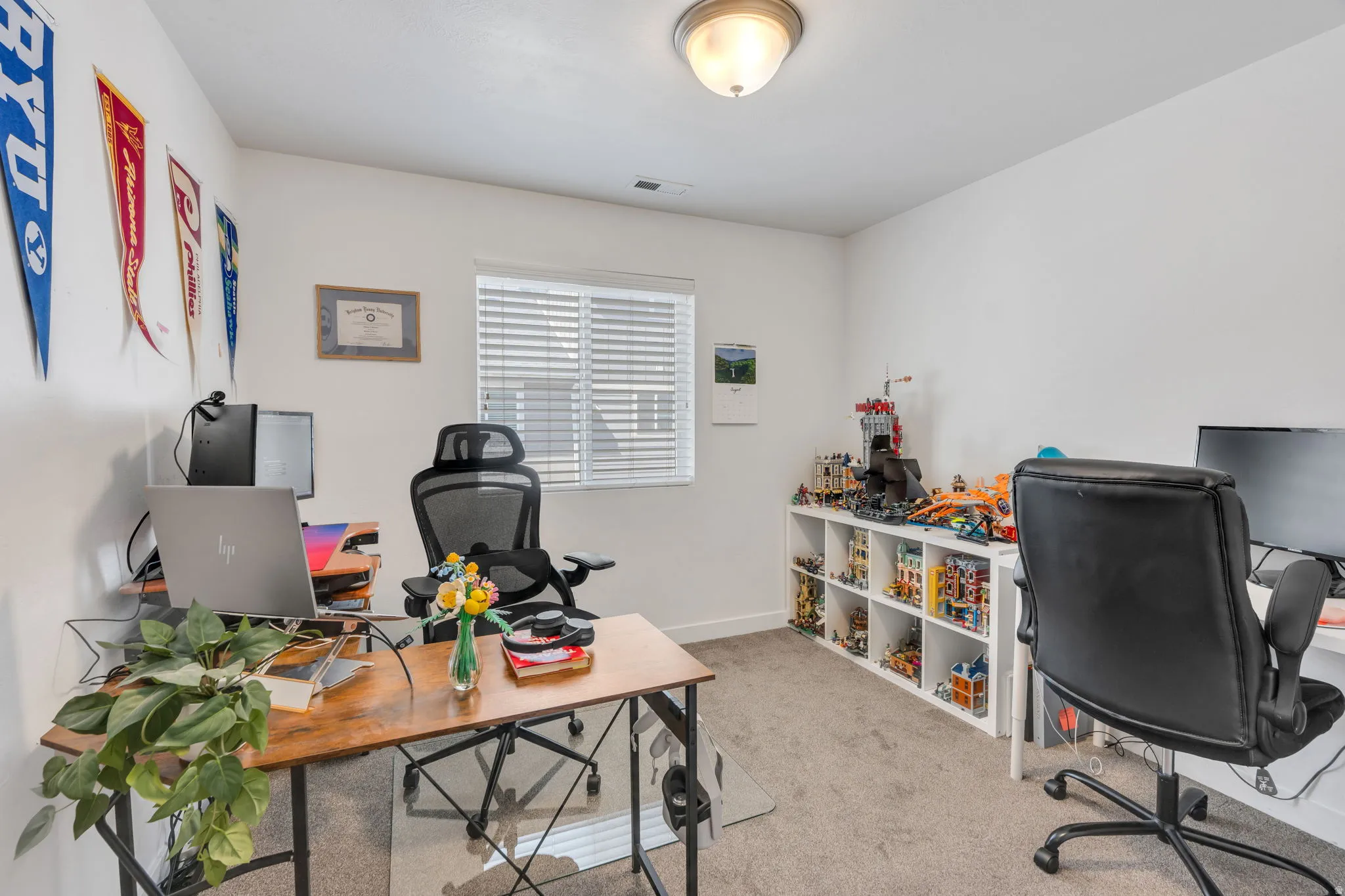 Recessed ceiling light fixture, window with blinds, and built-in shelving unit