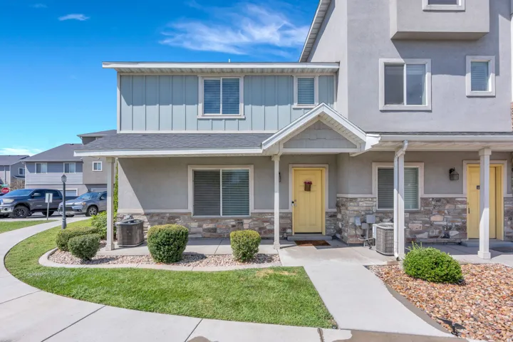 Stucco and stone veneer exterior with a covered entry
