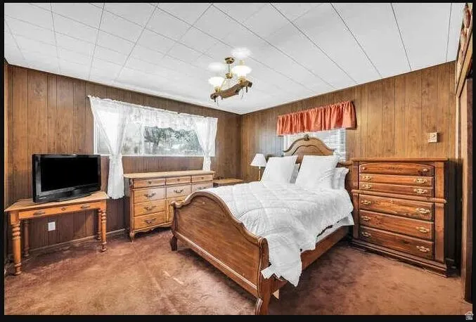 Wood paneling throughout, ceiling with grid pattern, and a central ceiling light fixture