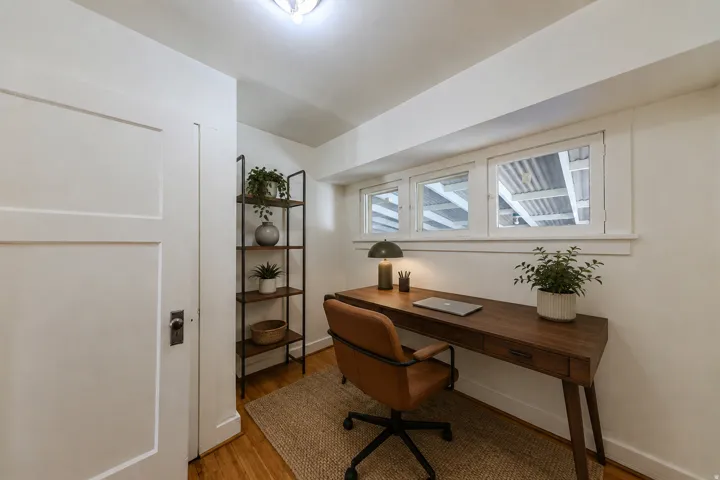 Wood-finish flooring with white walls and trim