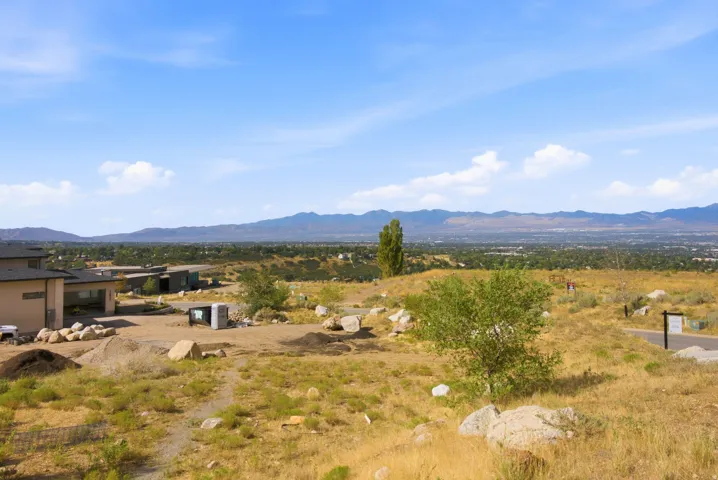 Expansive landscape with distant mountains under a clear sky